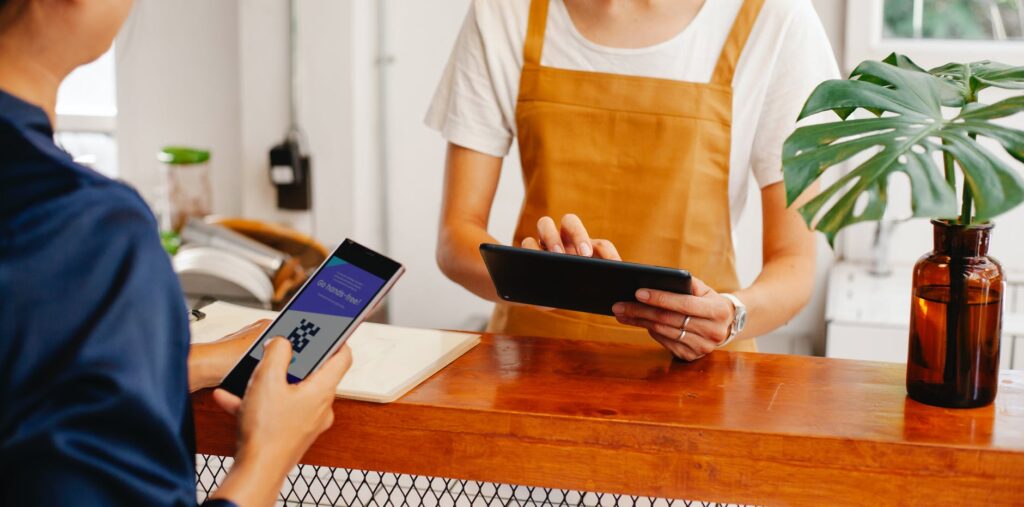People scanning and paying for their orders through contactless QR code menu system.